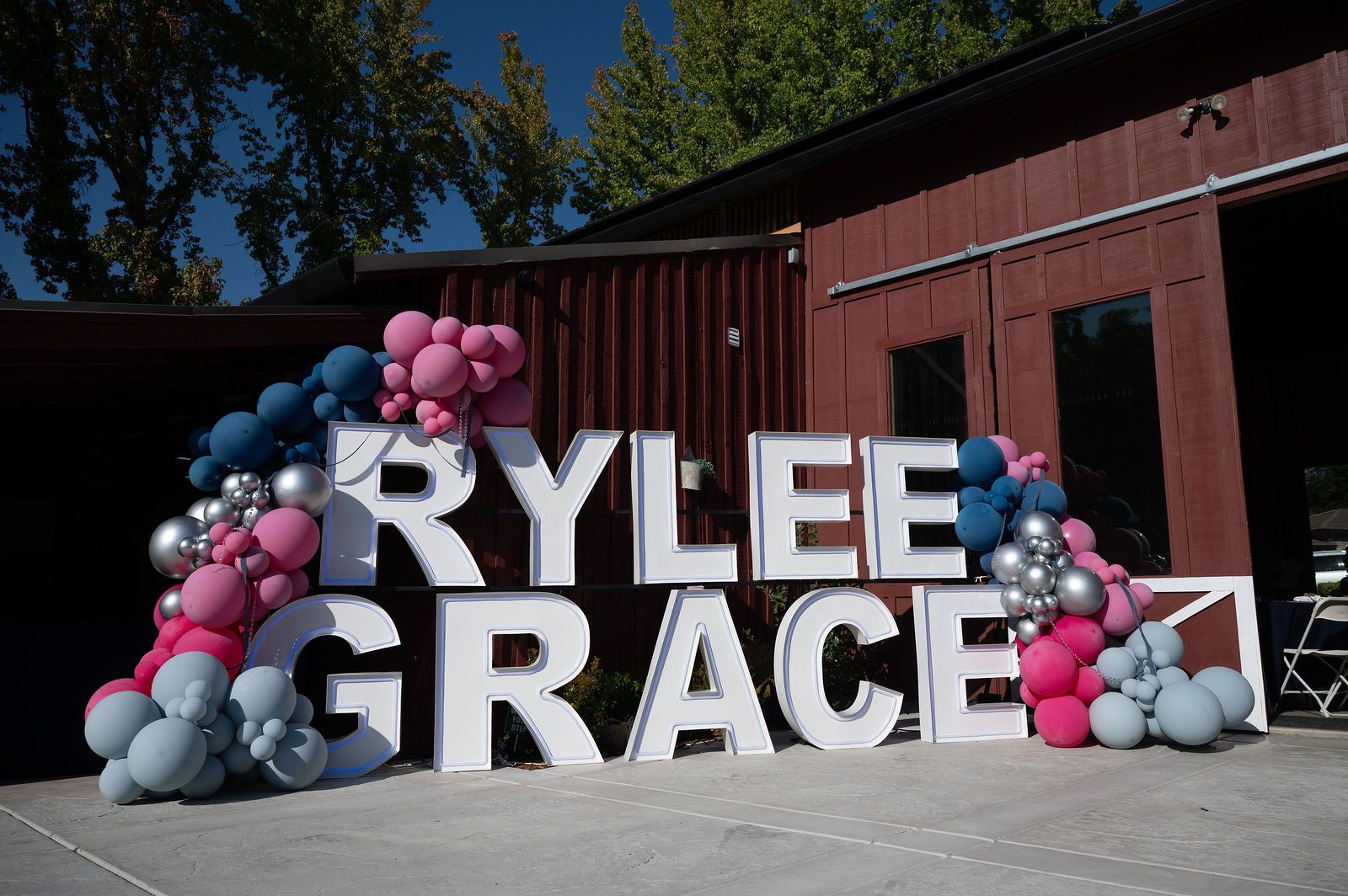 The RYLEE GRACE marquee letters with pink, blue and silver balloons outside The Red Barn at Denim and Diamonds 2025